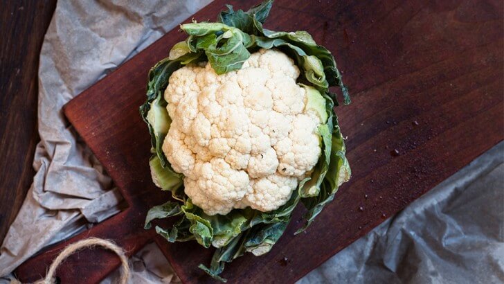 A cauliflower on a chopping board