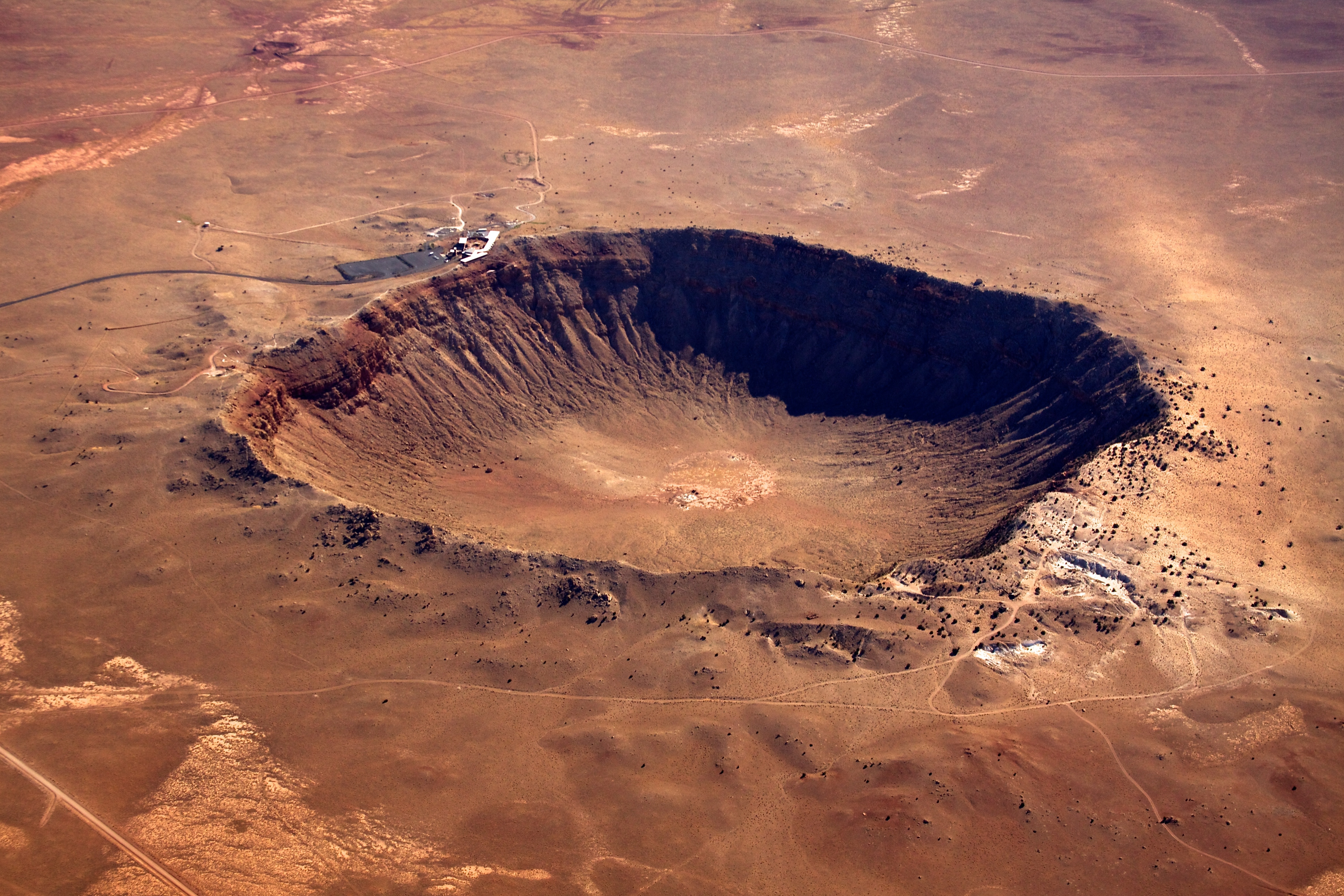 Arial shot of hole in the ground after a meteor strike