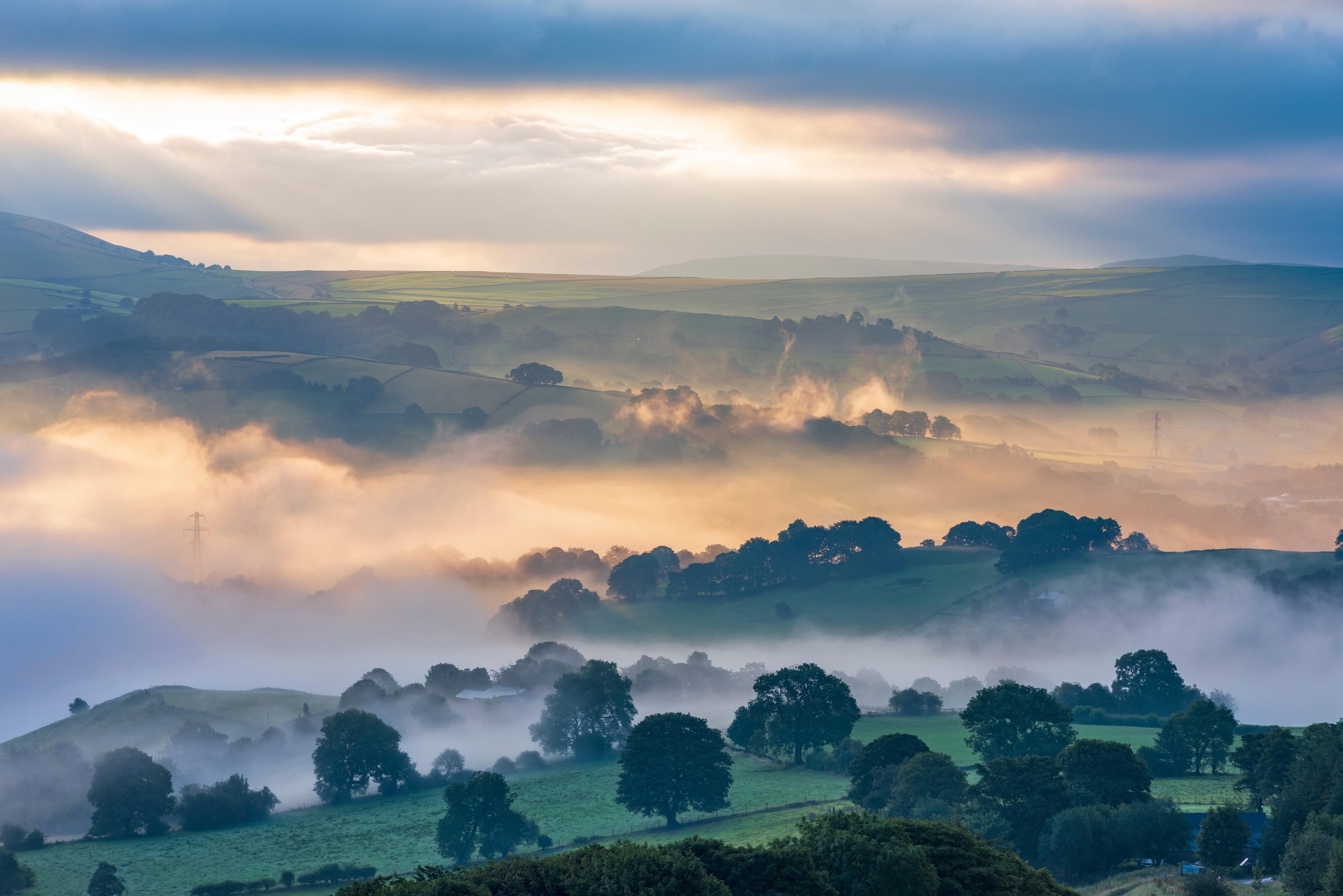 A stunning sunrise on a misty and foggy morning around the valleys